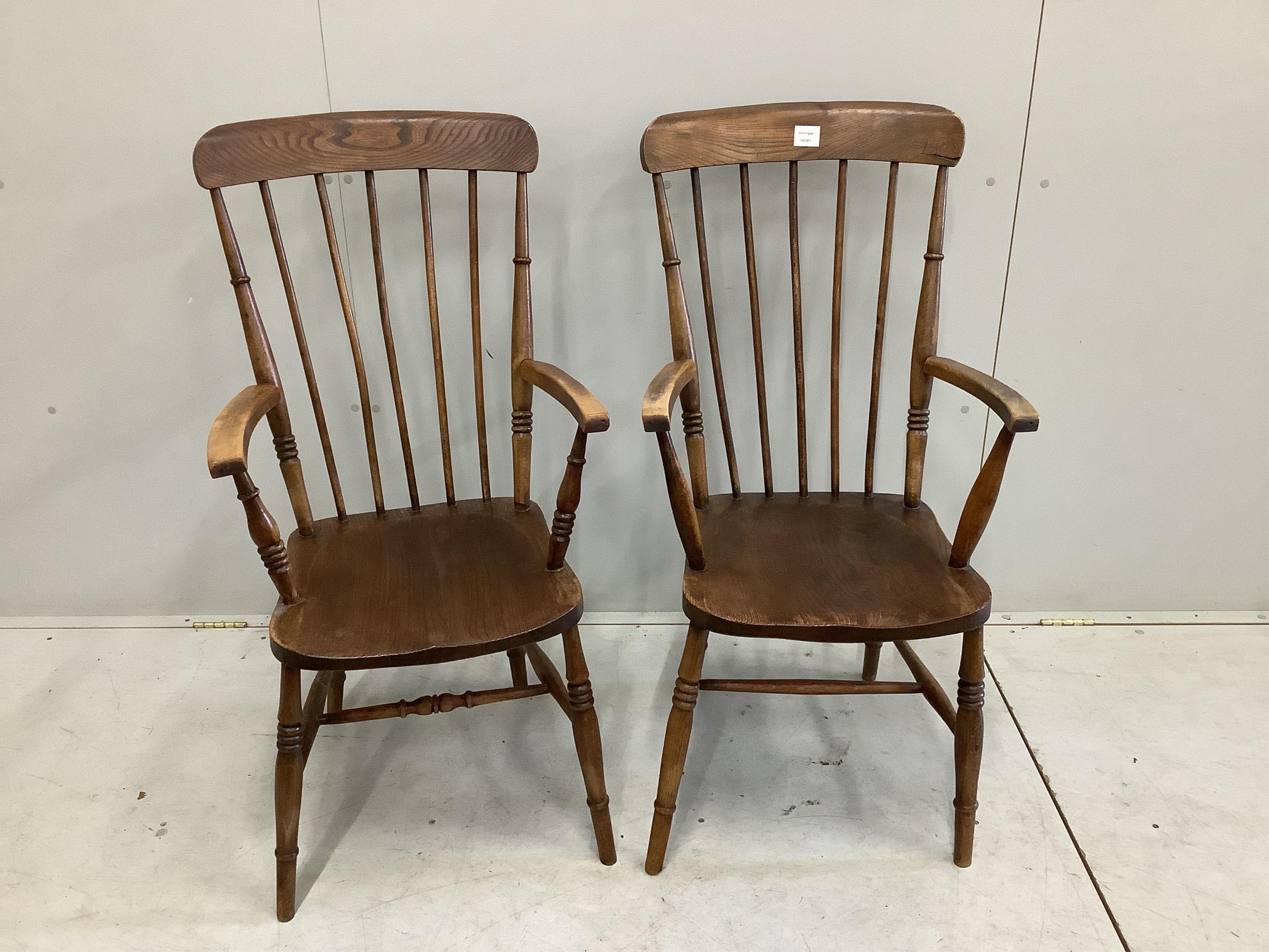 A pair of mid 19th century ash, elm and beech Windsor comb back armchairs, width 52cm, depth 44cm, height 105cm. Condition - fair